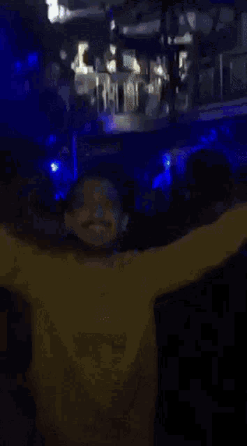 a group of people are dancing in a dark room