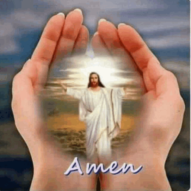 a person is holding a picture of jesus in their hands with the words amen .