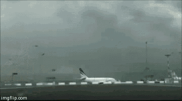 a plane is taking off from an airport runway and the website imgflip.com is visible