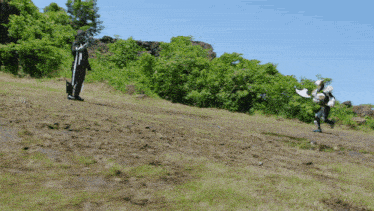 a man in a black and white costume is running down a dirt path