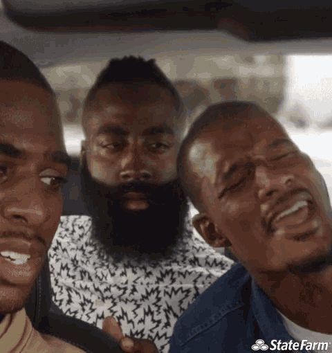 three men are sitting in a car with a state farm logo on the bottom right