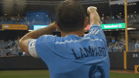 a man in a lampard jersey holds his head