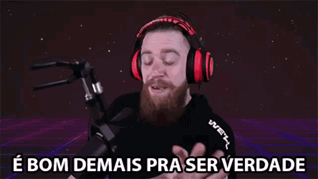 a man with a beard is wearing headphones and a microphone .
