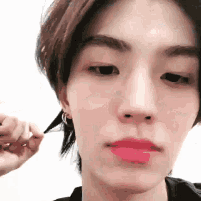 a close up of a person 's face with pink lipstick on their lips
