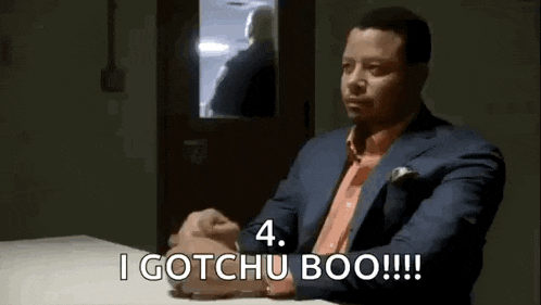 a man in a suit is sitting at a table and saying `` i gotchu boo ! ''