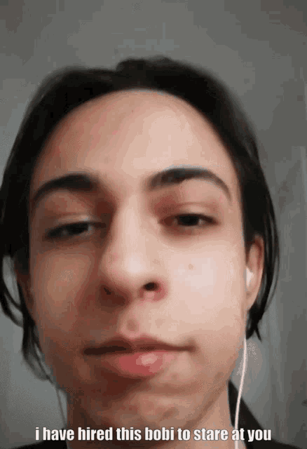 a close up of a person 's face with the words i have hired this bobi to stare at you