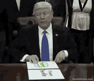 donald trump is sitting at a table with a drawing of a hamburger on a piece of paper that says ham