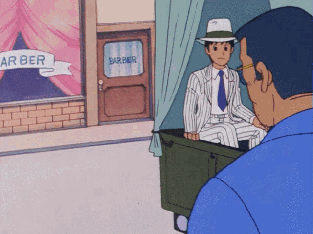 a man in a suit is sitting in front of a barber shop