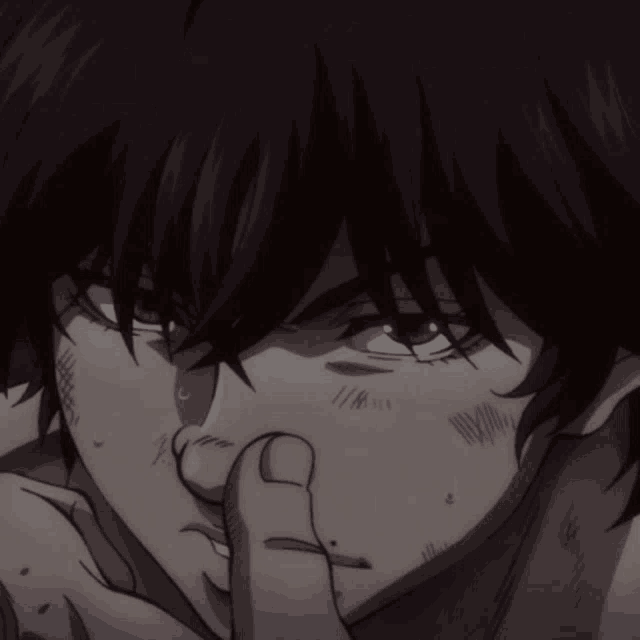 a close up of a person 's face with a finger in their nose