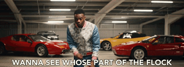a man is standing in a garage with cars and the words wanna see whose part of the flock on the bottom