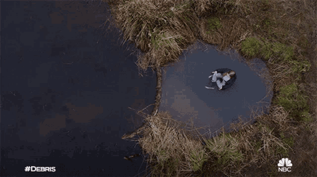 a nbc advertisement for #debris shows a tree branch in the water