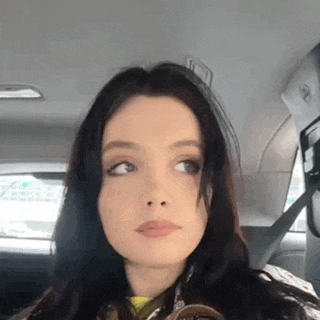 a close up of a woman sitting in the back seat of a car .