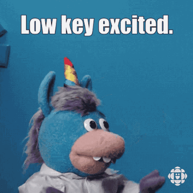 a stuffed animal with a unicorn horn and the words low key excited