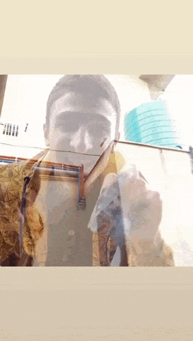 a man is taking a picture of himself with a picture frame behind him