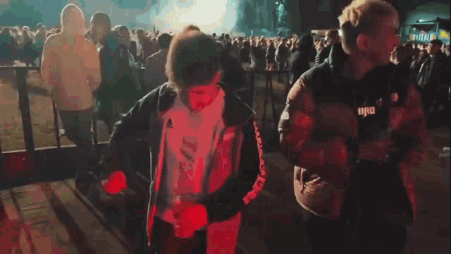 a group of people are dancing in front of a crowd at a concert .