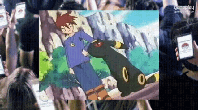 a group of people are looking at a picture of a boy and a pokemon