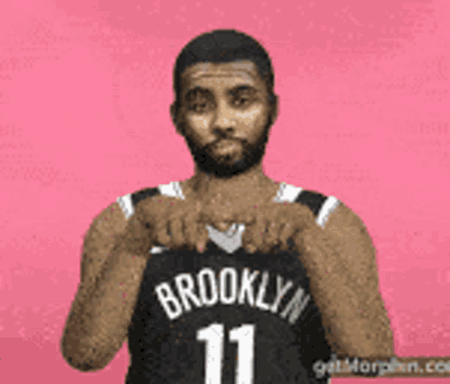 a man wearing a brooklyn jersey with the number 11