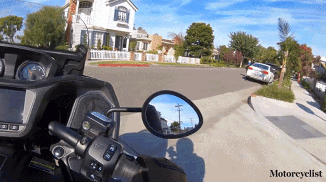 a motorcycle is driving down a street with the word motorcyclist on the bottom left