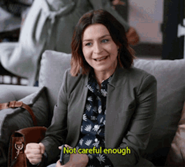a woman is sitting on a couch with the words not careful enough written above her