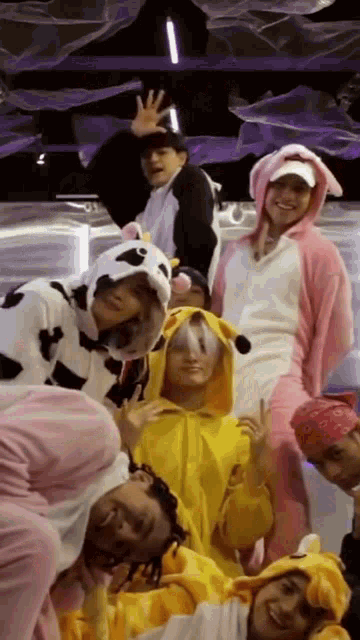 a group of people are posing for a picture while wearing costumes .