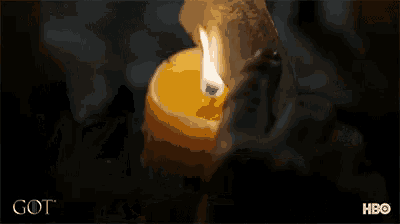 a person is holding a lit candle in front of a got advertisement