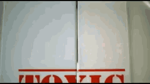 a white sign with red letters that says toxic on it