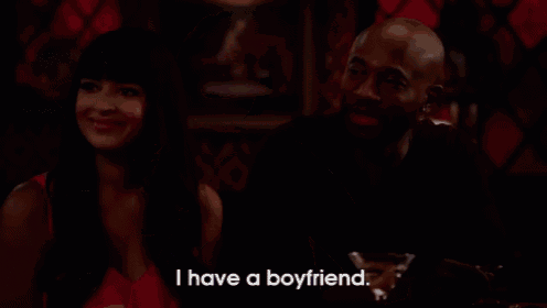 a woman sitting at a bar with a glass of wine and says i have a boyfriend