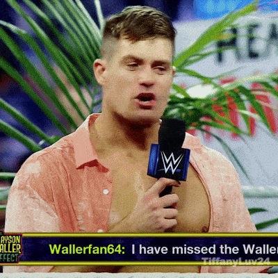 a man in a pink shirt is holding a microphone with a w on it