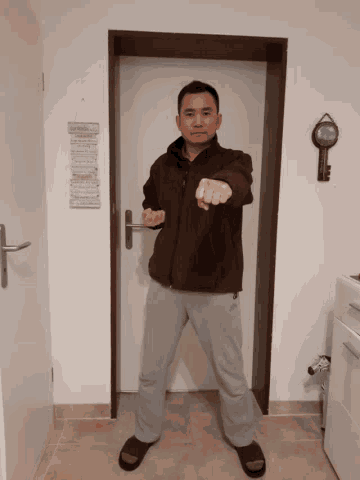 a man standing in front of a door with a sign on the wall that says " a few words "