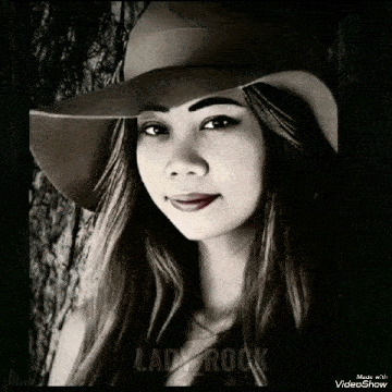 a black and white photo of a woman wearing a hat with lady rock written on the bottom right