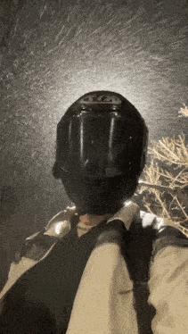a person wearing a black helmet that says ' kyt ' on the front of it