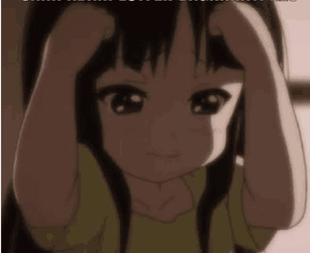 a little girl is holding her head with her hands while looking at the camera .