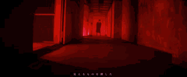 a person walking down a hallway with chinese writing