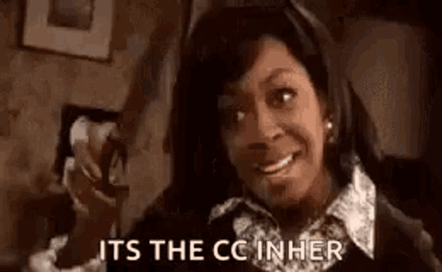 a woman is smiling and pointing at the camera while saying `` it 's the cc inher '' .