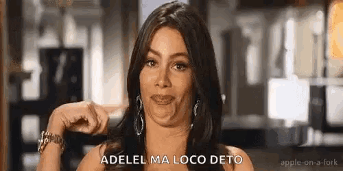 a woman is making a funny face and pointing at herself with her finger .