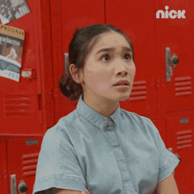 a girl sitting in front of red lockers with a nick logo on the bottom right