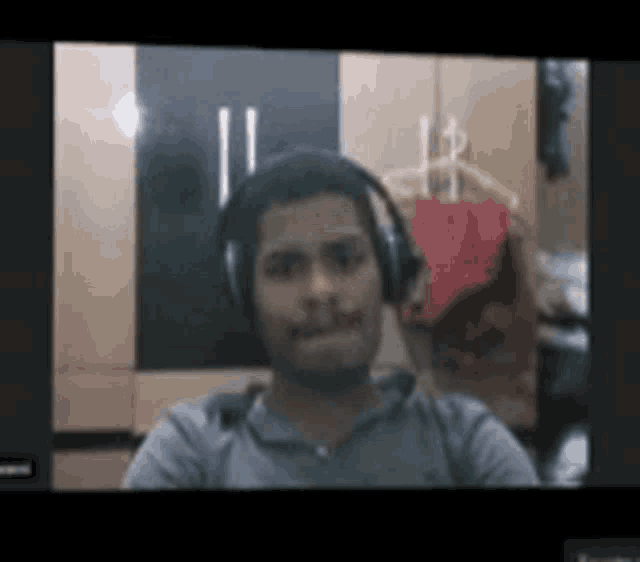 a man wearing headphones is taking a selfie