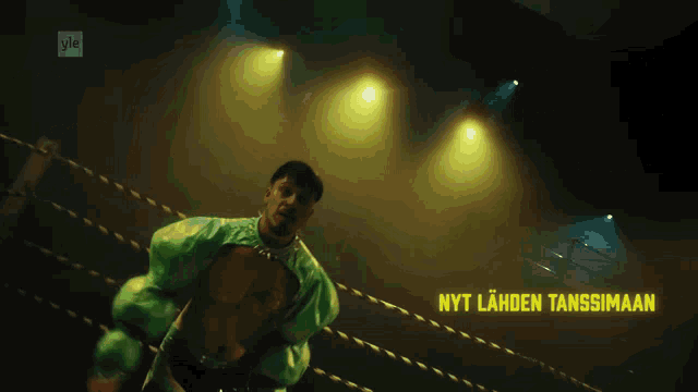 a man in a green outfit is in a boxing ring with the words nyt lahden tanssimaan written on it