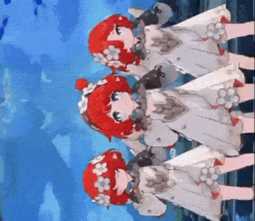 three little girls with red hair and white dresses are standing next to each other in a row .