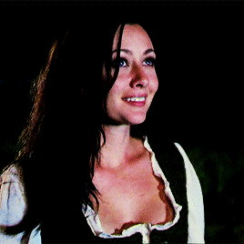 a woman with a plunging neckline is smiling and looking up