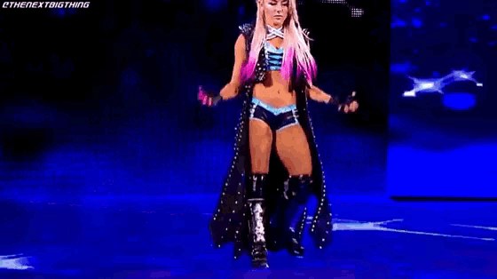 a woman is standing in front of a banner that says alexa bliss on it .