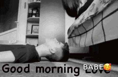 a black and white photo of a man laying on the floor with the words `` good morning babe '' written below him .