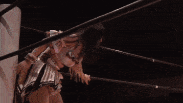 a woman is standing in a wrestling ring with her mouth open ..
