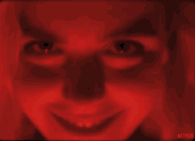 a close up of a woman 's face in a red light with netflix written on the bottom