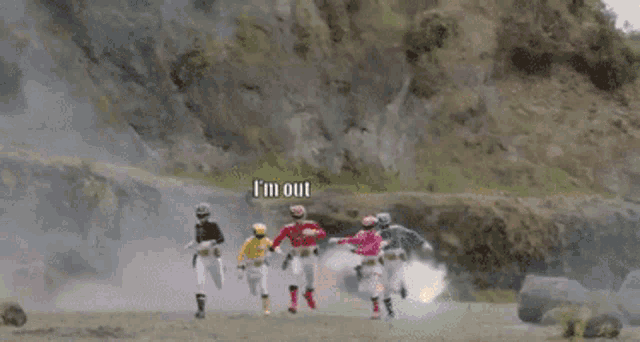 a group of power rangers are running in front of an explosion and a caption that says i 'm out
