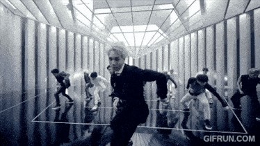 a black and white photo of a group of people dancing with gifrun.com written in the corner