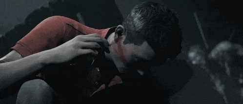 a man in a red shirt has a hole in his neck