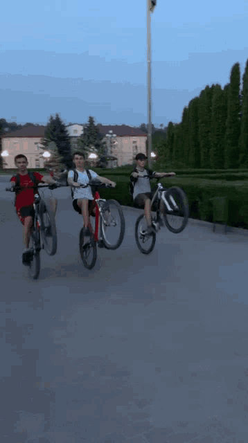a group of people riding bicycles on a street