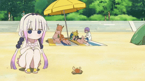a girl is sitting on the beach next to a crab and a tent .