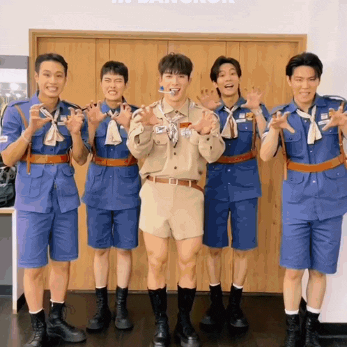 a group of young men are posing for a picture and one of them has a name tag that says ' a '